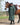 EQUIDRY women's long waterproof horse riding coat in black forest green/green shown by rider stood with horse