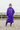 EQUIDRY women's long waterproof horse riding coat in deep purple modelled by rider in arena