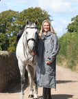 EQUIDRY waterproof horse riding raincoat All Rounder Original thick fleece Women's Charcoal/Grey full view rider stood with horse