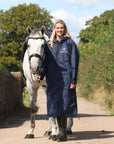 EQUIDRY waterproof horse riding raincoat All Rounder Original thick fleece Women's Navy/Pale Pink full view stood with horse