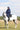 EQUIDRY waterproof horse riding raincoat All Rounder Original thick fleece Women's Navy/Pale Pink side view rider on horse