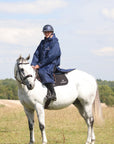 EQUIDRY waterproof horse riding raincoat All Rounder Original thick fleece Women's Navy/Pale Pink side view rider on horse