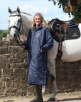 EQUIDRY waterproof horse riding raincoat All Rounder Original thick fleece Women's Navy/Raspberry full view stood with horse