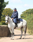 EQUIDRY waterproof horse riding raincoat All Rounder Original thick fleece Women's Navy/Raspberry side view on horse