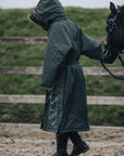 EQUIDRY | Parka | Women's | Black Forest Green - waterproof riding and leisure coat with padded inner detachable faux fur trim back view hood up rider in arena