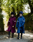 EQUIDRY waterproof horse riding raincoat thin fleece pro ride reflective kids plum and steel blue children's jackets both walking front full view 