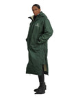 EQUIDRY women's long waterproof horse riding coat in Black Forest Green/Cream studio side view showing side zips and storm skirts 