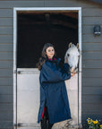 EQUIDRY Pro Ride Evolution Equestrian oversized waterproof Horse Riding Coat in Navy with Raspberry lining worn by young rider at stables with Pony