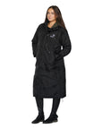 EQUIDRY women's long waterproof horse riding coat in Black/Olive Green front view full length modelled by rider 