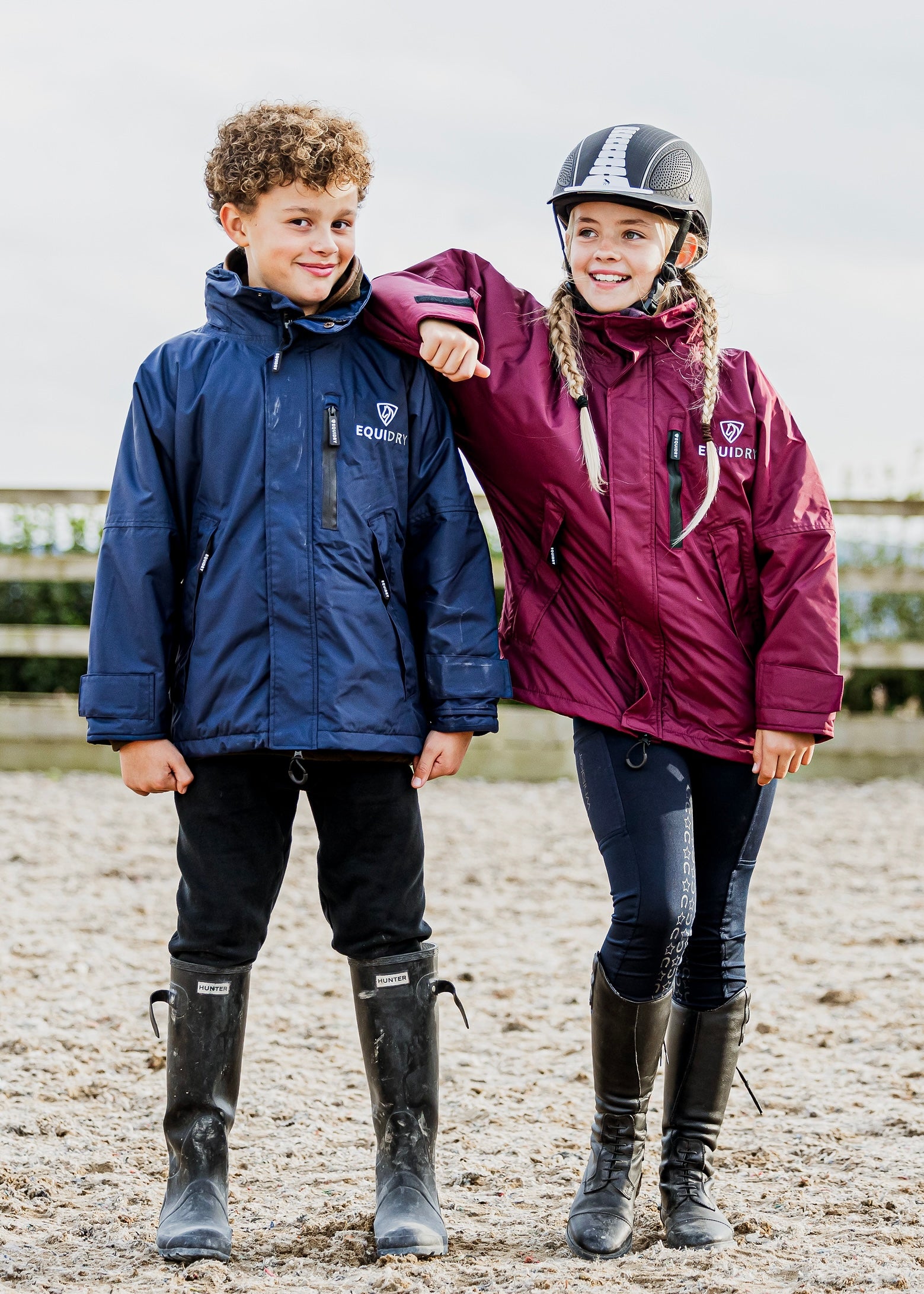 Shortie Child's Oversized Short Waterproof blouson style Riding Jacket Thin Fleece Lining Stowaway Hood in plum and navy in arena