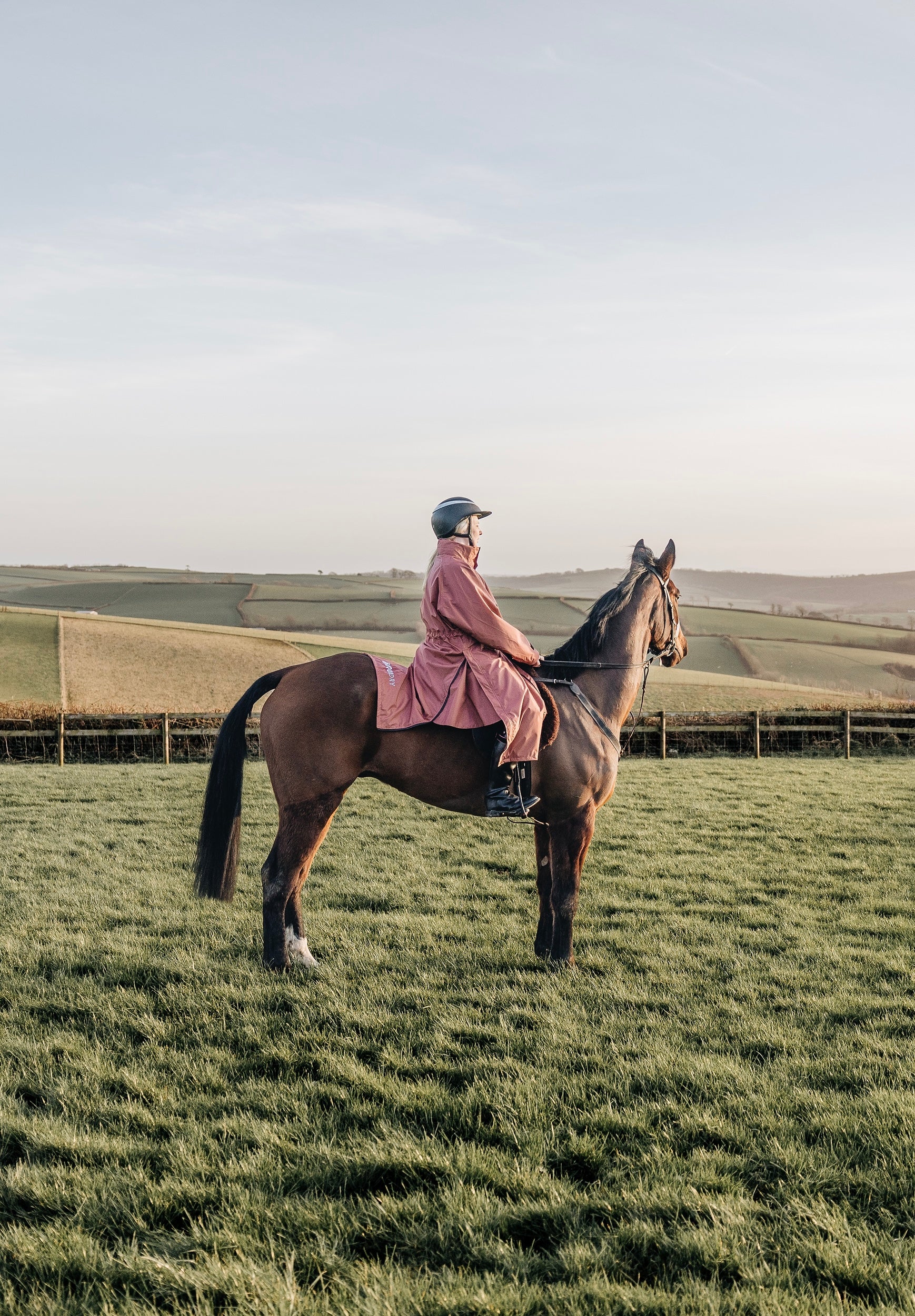 EQUIDRY equimac long waterproof horse riding coat modelled by lady on horseback