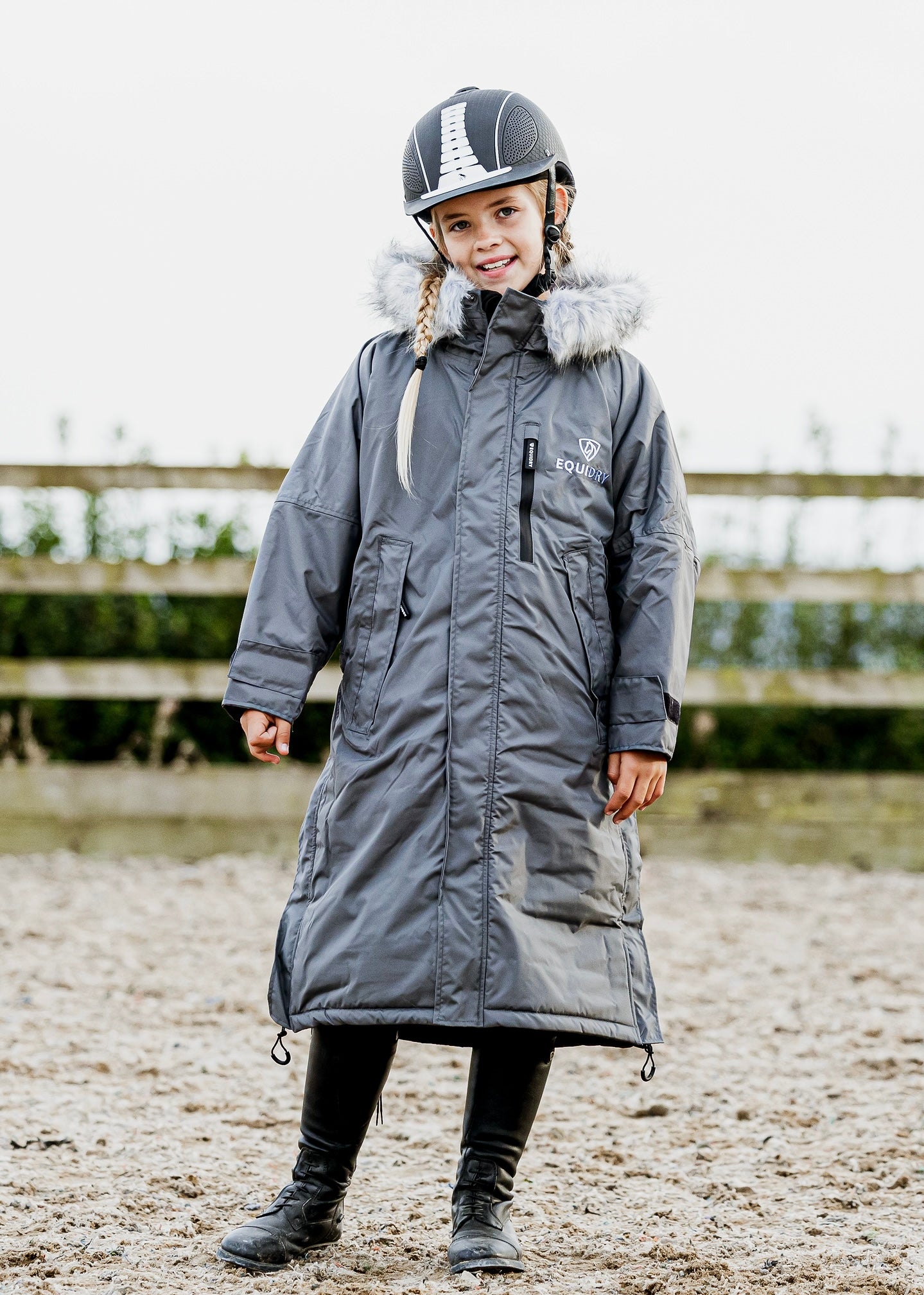 EQUIDRY Evolution Lux children's Warm Waterproof Winter Horse Riding Coat Thick Fleece Lining with Faux Fur Trim Hood being shown in charcoal/lilac 