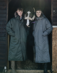 EQUIDRY Parka  with fur hood modelled by men on stable yard next to a horse