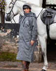 EQUIDRY women's thin fleece stowaway hood long waterproof horse riding coat in charcoal/penelope pink stood with horse