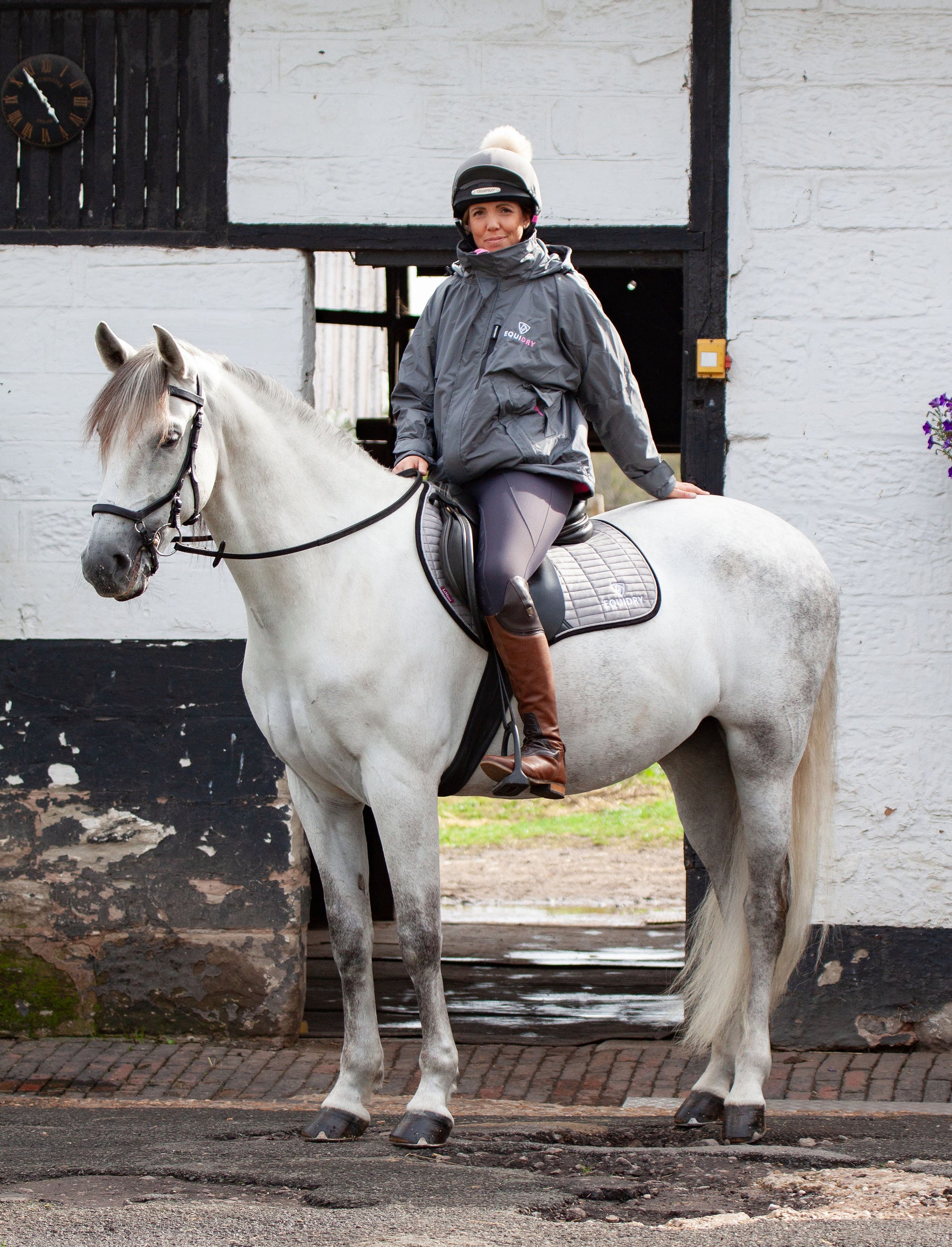 EQUIDRY women's waterproof short blouson style horse riding jacket in charcoal/penelope pink on horse 