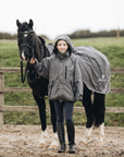 Shortie Child's Oversized Short Waterproof blouson style Riding Jacket Thin Fleece Lining Stowaway Hood in charcoal/grey girl with horse wearing matching exercise sheet