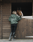 EQUIDRY women's waterproof short blouson style horse riding jacket in black forest green lifestyle with horse