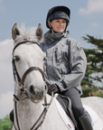 EQUIDRY women's waterproof short blouson style horse riding jacket in charcoal/lilac on horse